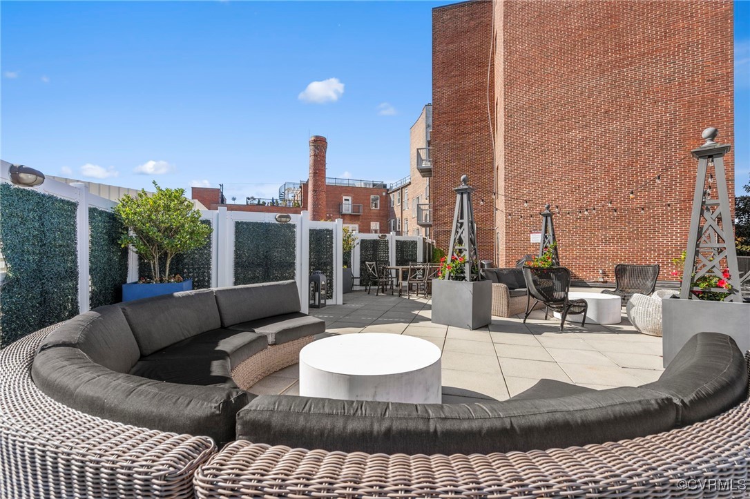 413 Stuart Circle, Unit PLD Richmond, VA 23220 - Photo 31 of 47 a view of a roof deck with couches and potted plants