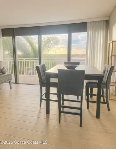 a bedroom with a large bed and a flat tv screen on dresser