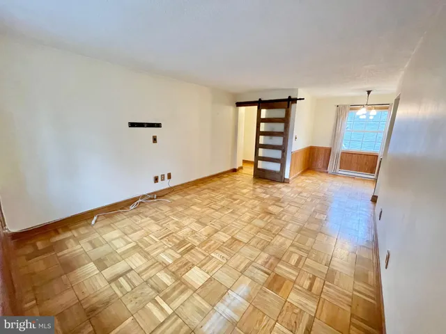 a view of a livingroom with wooden furniture