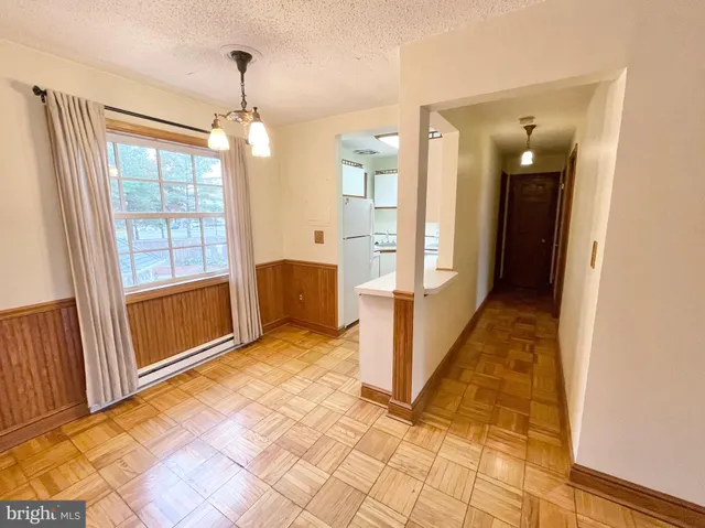 a living room with a baby crib furniture and a window