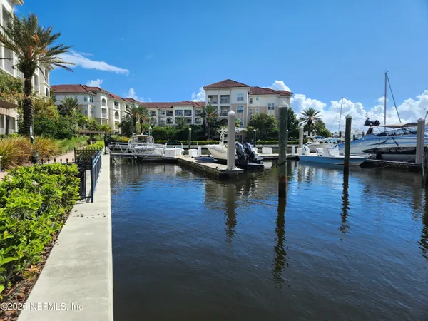 a view of swimming pool with outdoor seating and plants