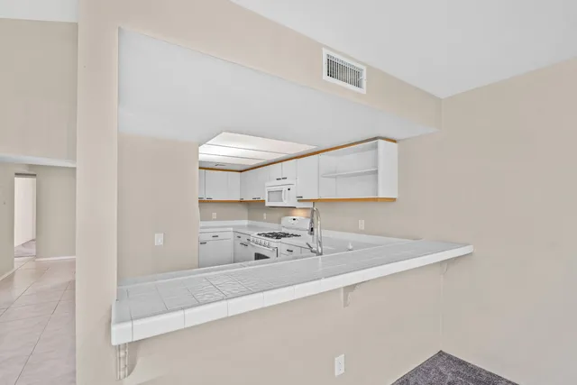 a kitchen with stainless steel appliances a sink a stove and a refrigerator