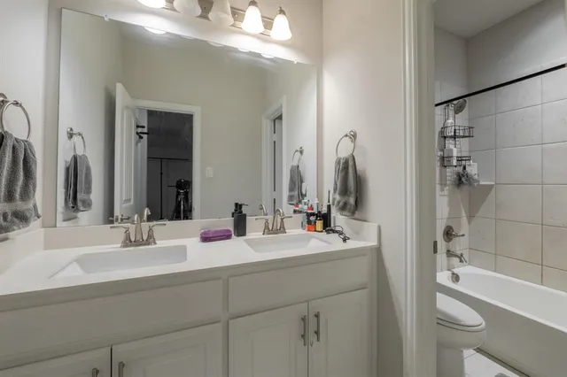 a bathroom with a double vanity sink mirror double vanity tub and shower