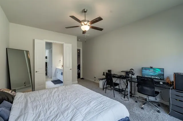 a bedroom with a bed a desk and chair