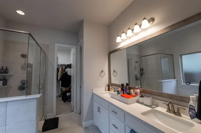a bathroom with a sink double vanity and a shower