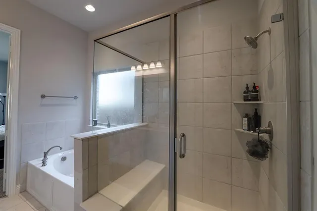 a bathroom with a bathtub and shower