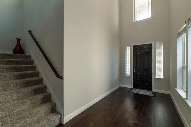a view of entryway with wooden floor and stairs