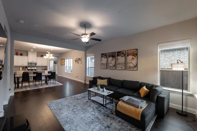 a living room with furniture and wooden floor