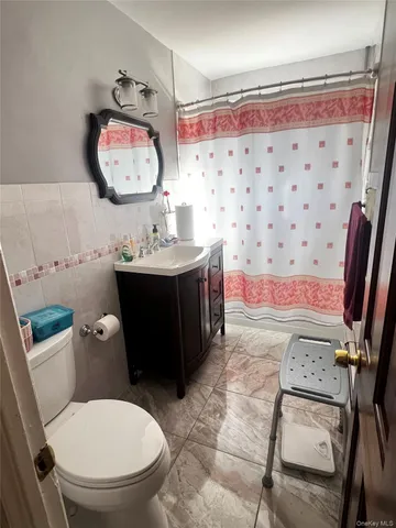 a bathroom with a toilet a sink and a mirror