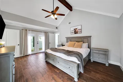 a bed room with a bed and a ceiling fan
