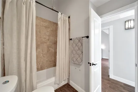 a bathroom with a shower and a toilet