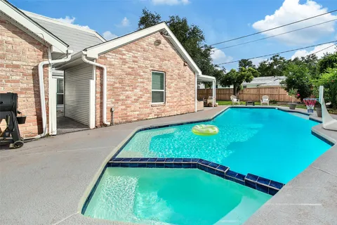 a backyard of a house with table and chairs
