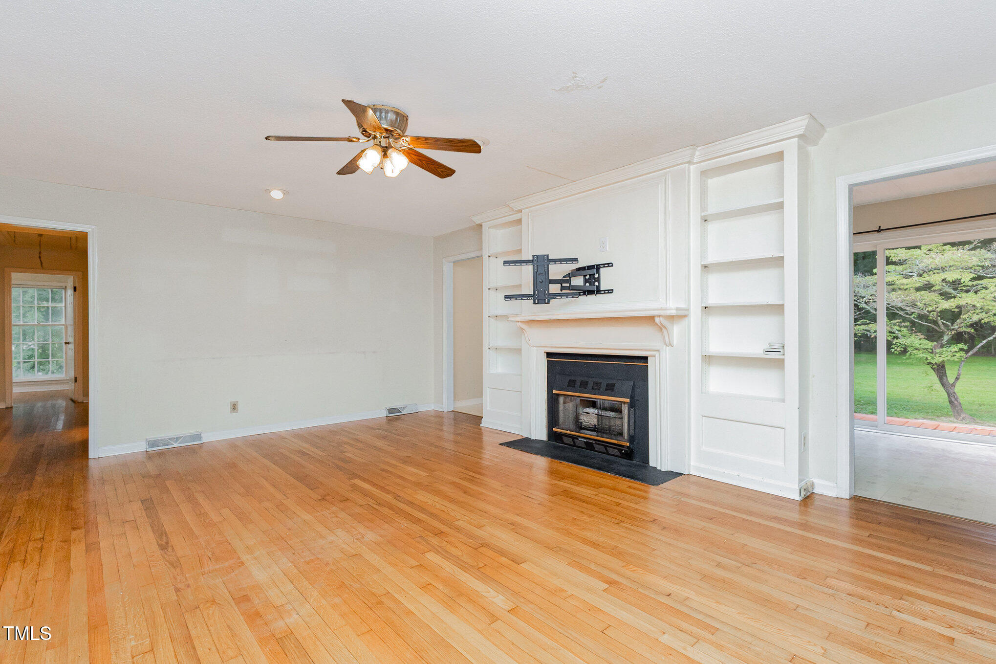 316 Cheeks Lane Graham, NC 27253 - Photo 19 of 52 a view of empty room with wooden floor and fireplace