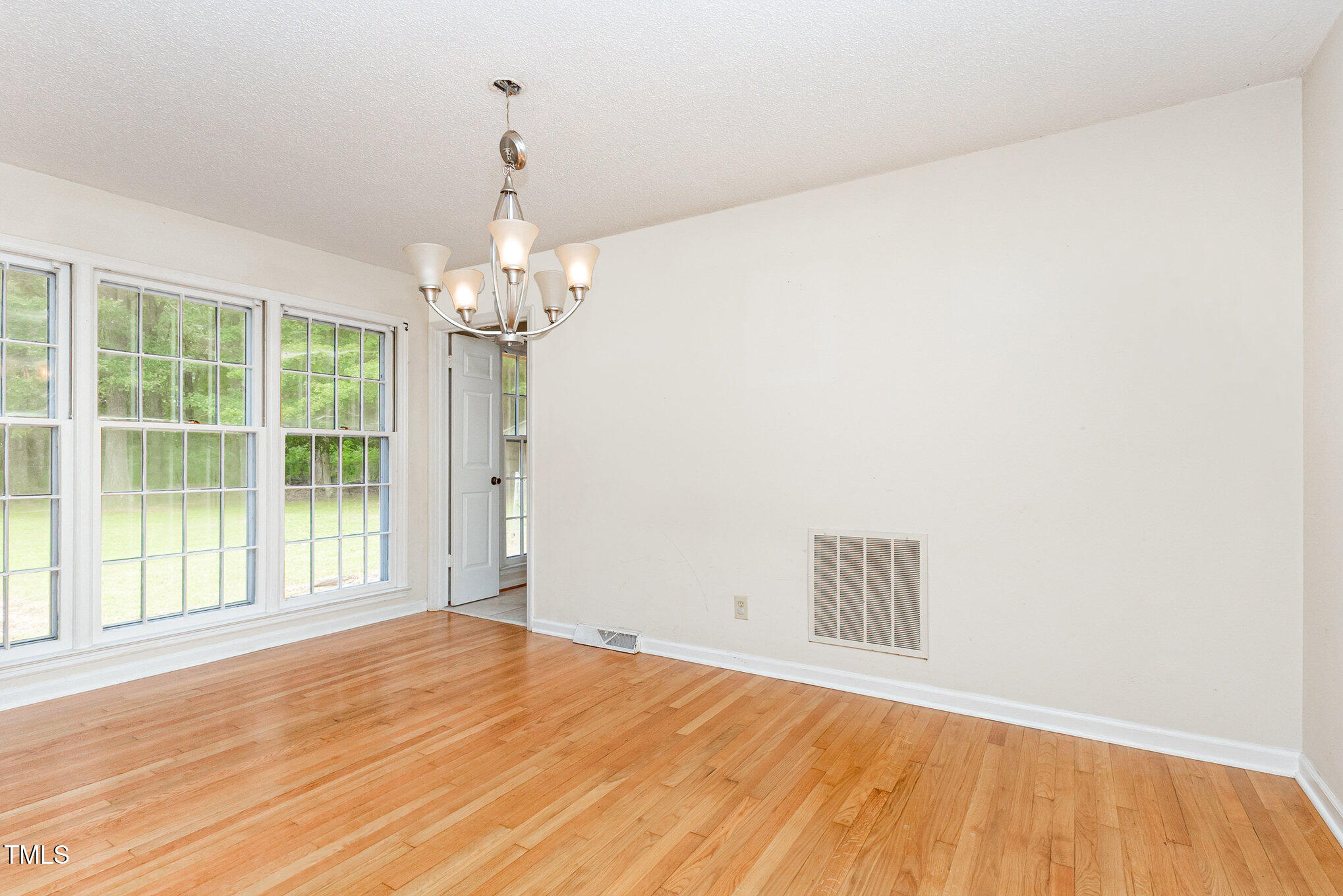 316 Cheeks Lane Graham, NC 27253 - Photo 23 of 52 a view of empty room with wooden floor and fan