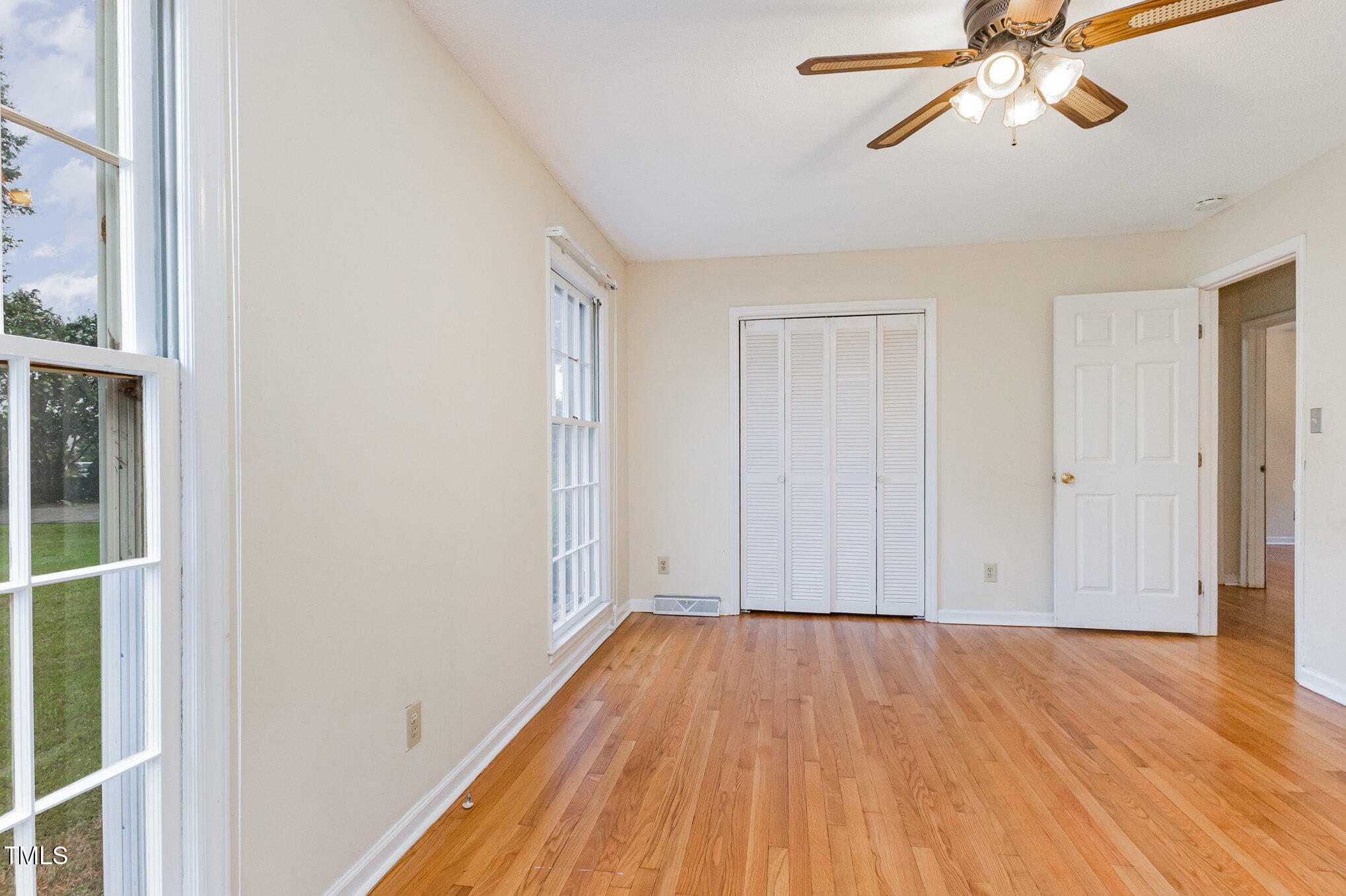 316 Cheeks Lane Graham, NC 27253 - Photo 34 of 52 a view of empty room with wooden floor and fan
