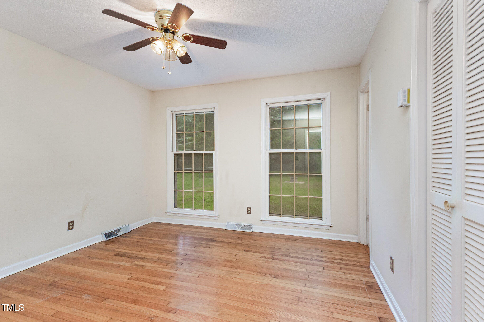 316 Cheeks Lane Graham, NC 27253 - Photo 36 of 52 a view of an empty room with a window and wooden floor