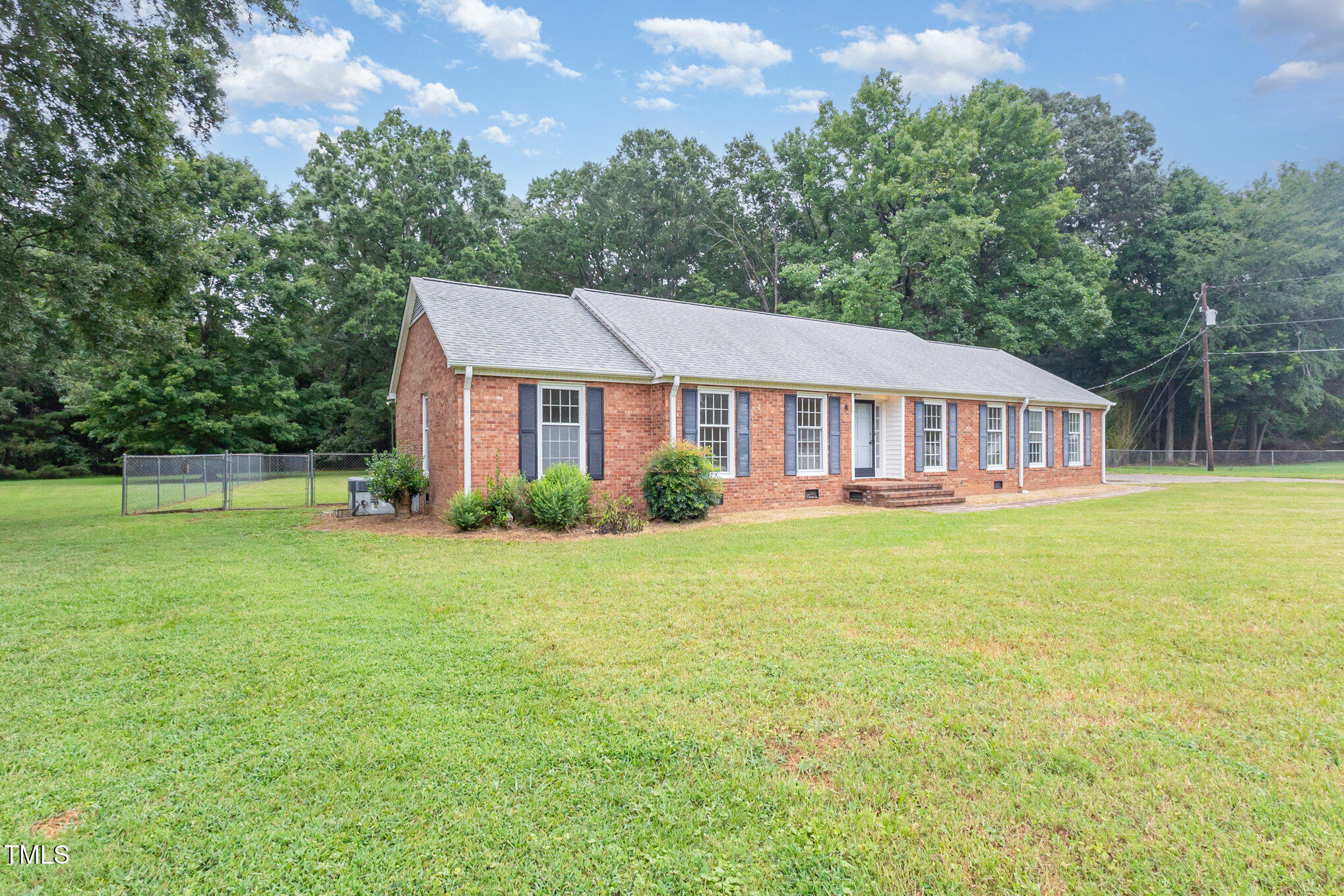 316 Cheeks Lane Graham, NC 27253 - Photo 7 of 52 a front view of a house with a garden