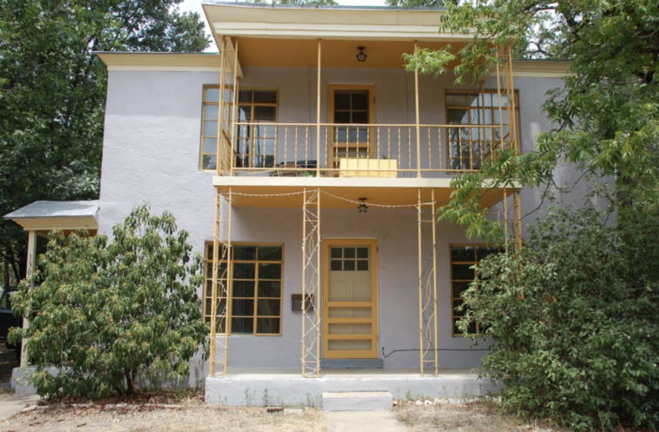 1302 Kirkwood Road, Unit B Austin, TX 78722 - Photo 1 of 12 Two-story stucco exterior featuring a ground-level porch and an upper-level balcony, both with decorative metal railings