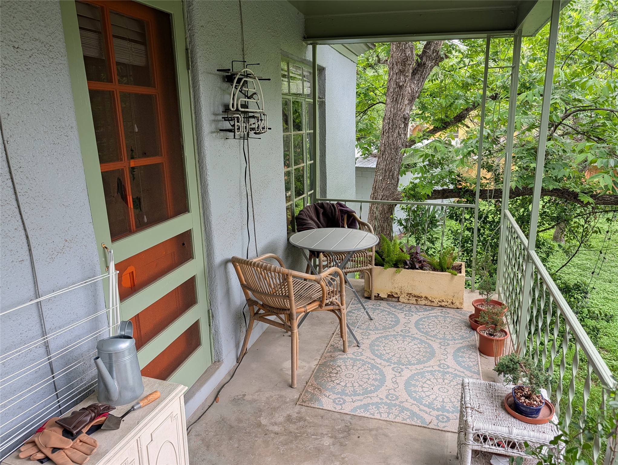 1302 Kirkwood Road, Unit B Austin, TX 78722 - Photo 12 of 12 Covered outdoor balcony featuring a concrete floor and a metal railing
