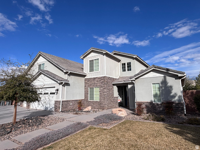 429 East Treasure Road Washington, UT 84780 - Photo 3 of 36 View of front of property featuring stone siding, stucco siding, concrete driveway, and a tile roof