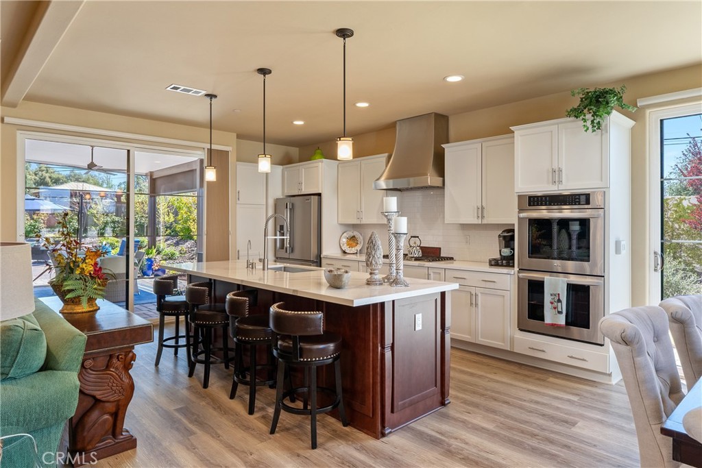 9300 Via Castillo Atascadero, CA 93422 - Photo 11 of 49 a kitchen with kitchen island granite countertop a table chairs sink and cabinets