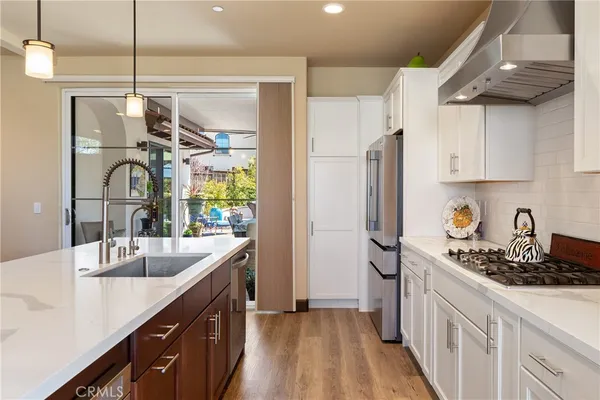 a kitchen with stainless steel appliances a sink stove and refrigerator
