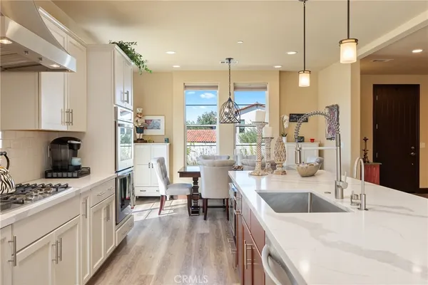 a kitchen with a sink stove and refrigerator