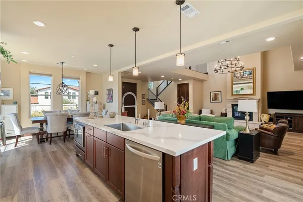 a large kitchen with kitchen island a sink table and chairs