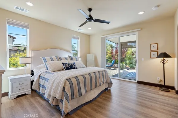 a spacious bedroom with a bed and a large window