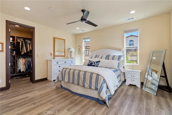 a spacious bedroom with a bed and a walk in closet
