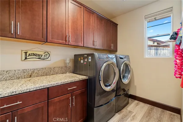 a view of a storage and utility room with washer and dryer