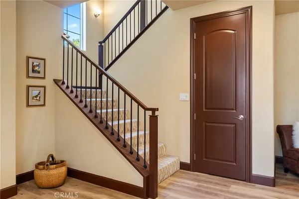 a view of entryway and hall with wooden floor
