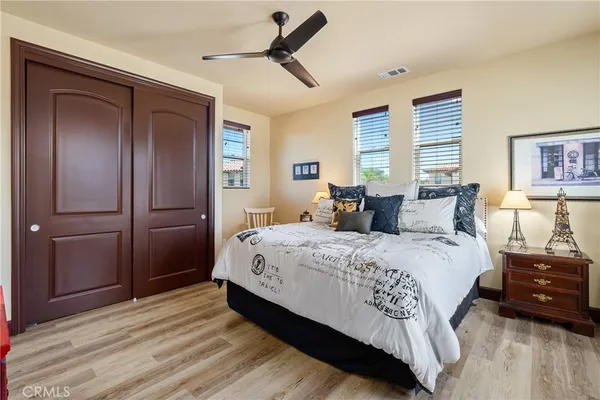 a spacious bedroom with a bed and a dresser