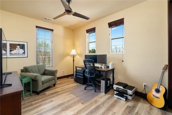 a livingroom with workspace and a window