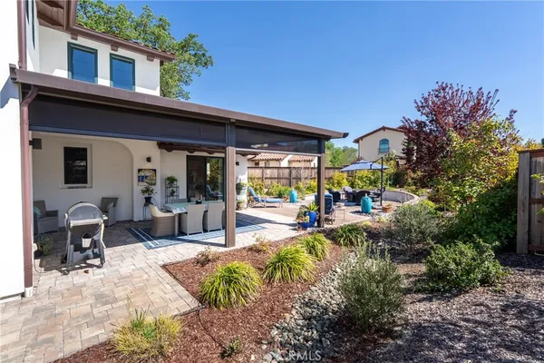 a view of a house with backyard porch and sitting area
