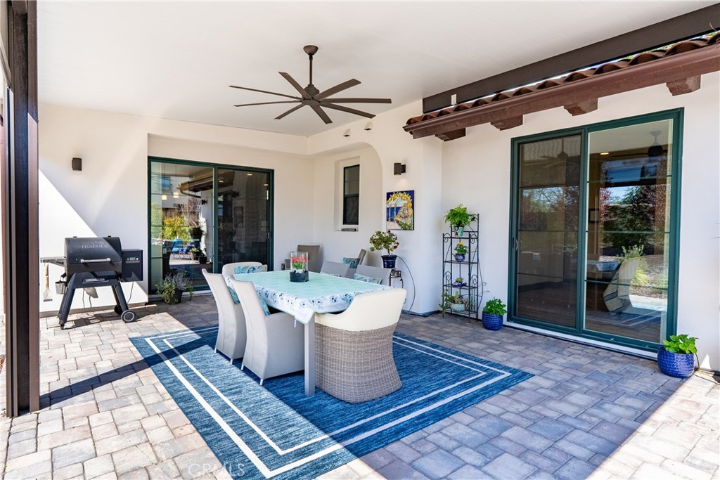 9300 Via Castillo Atascadero, CA 93422 - Photo 31 of 49 a living room with a rug floor to ceiling window and potted plants