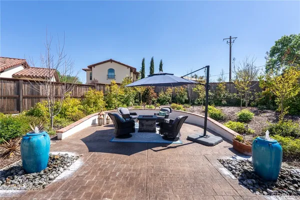 a view of a patio with couches chair and potted plants