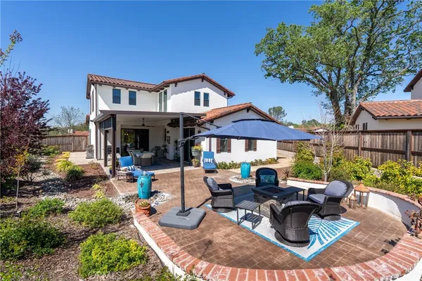 a view of a house with backyard porch and sitting area