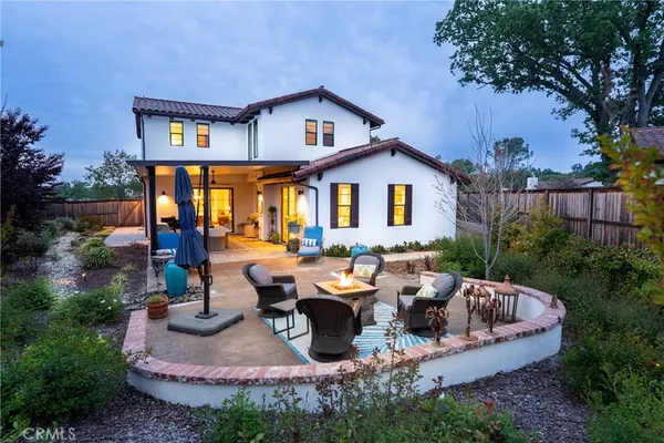a view of a house with backyard and sitting area