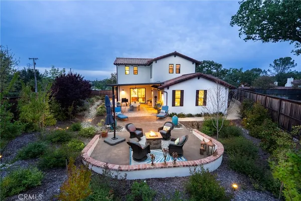 a view of a house with backyard outdoor seating and hardwood
