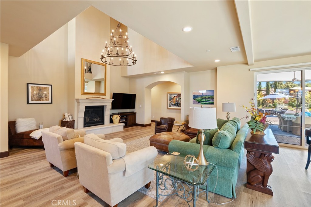 9300 Via Castillo Atascadero, CA 93422 - Photo 7 of 49 a living room with fireplace furniture and a chandelier