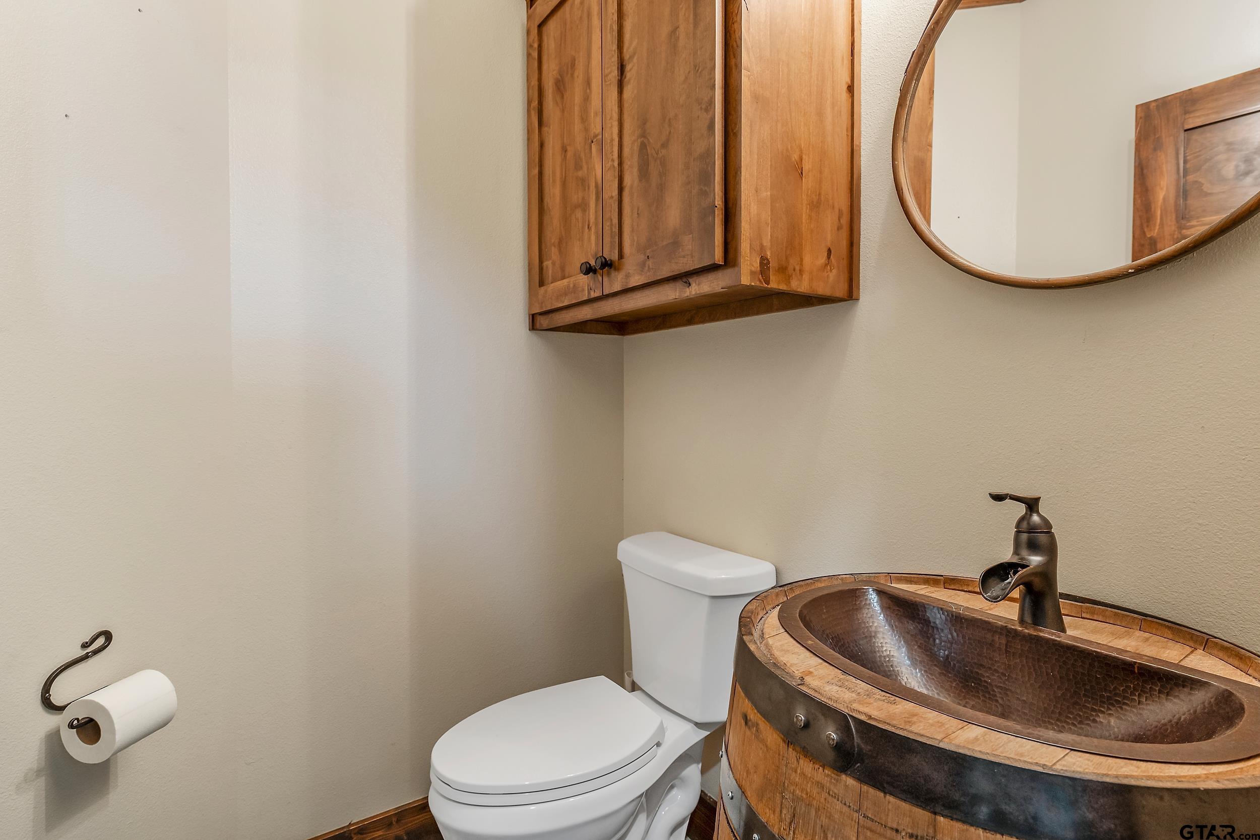 20122 County Road 452 Mineola, TX 75773 - Photo 33 of 41 a bathroom with a sink a toilet and mirror