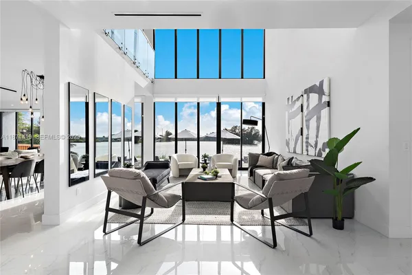 a living room with furniture and a view of kitchen