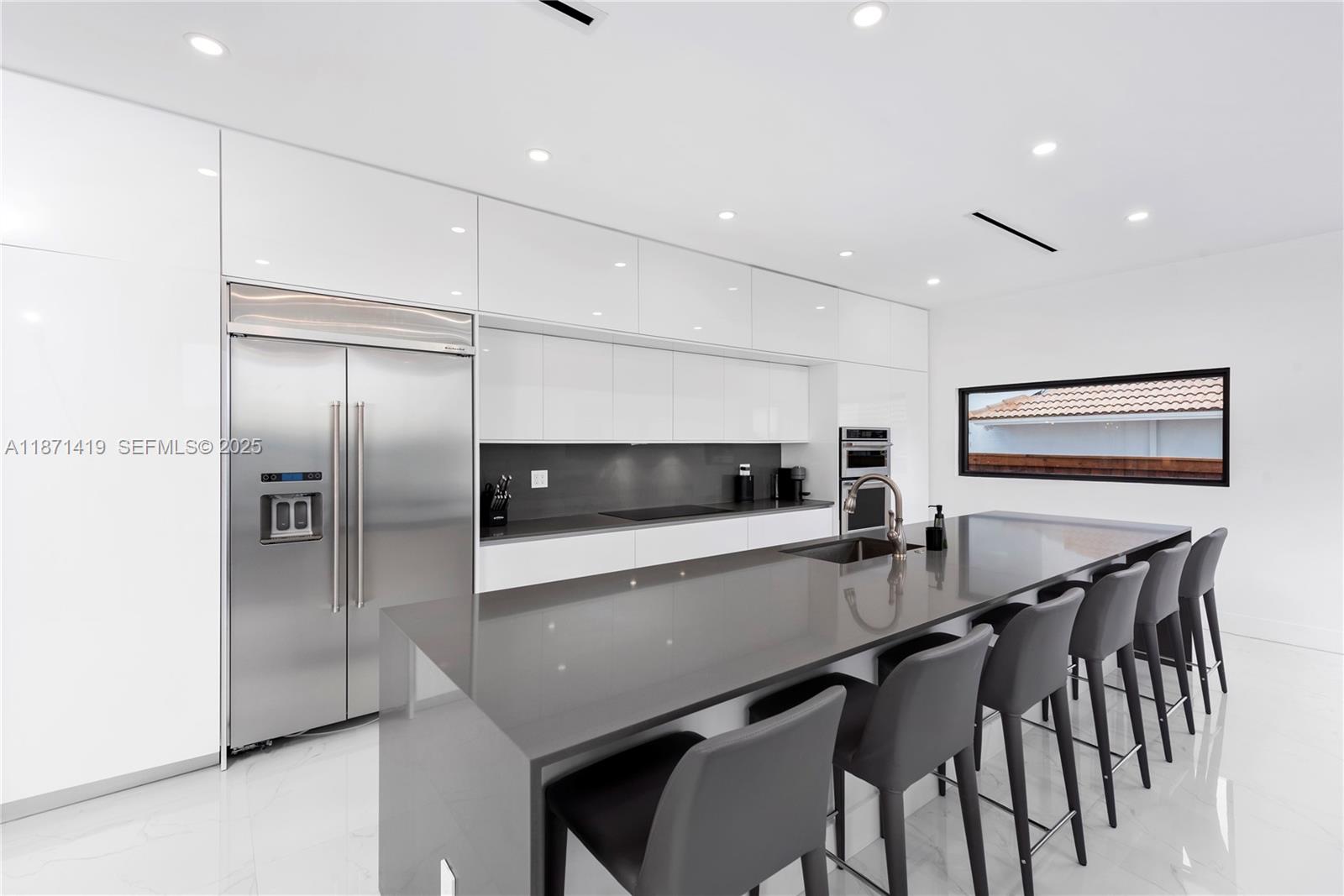 5420 Southwest 72nd Avenue Miami, FL 33155 - Photo 14 of 52 a kitchen with stainless steel appliances a refrigerator and a microwave