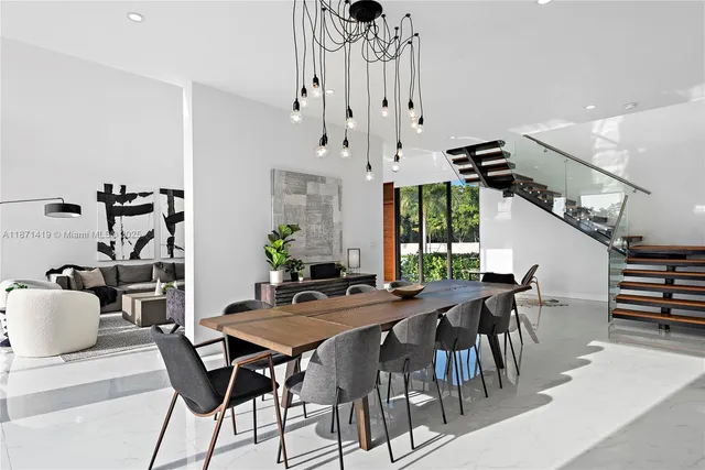 a kitchen with appliances cabinets and chairs