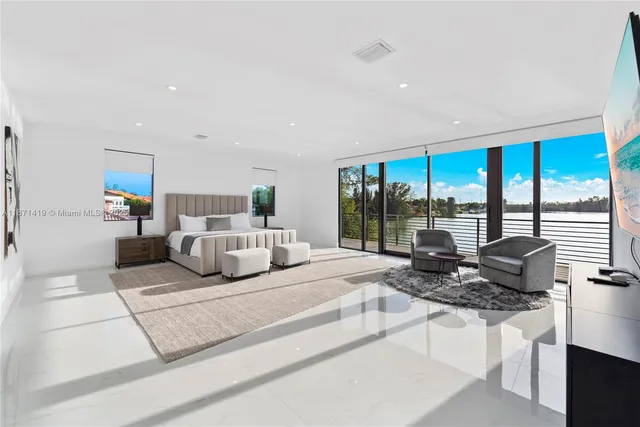 a spacious bedroom with a bed and a dresser