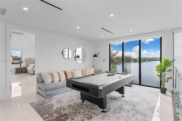 a room with furniture pool table and projector