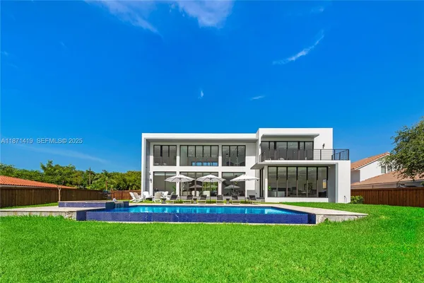 a view of an house with swimming pool and chairs