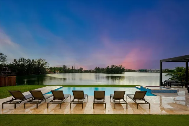 a house with outdoor seating and lake view