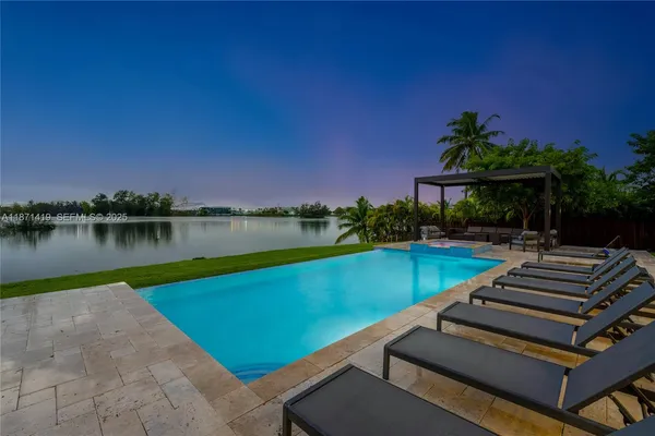 a view of a patio with swimming pool and a yard